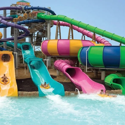 Colorful water slides and people enjoying them at a water park.