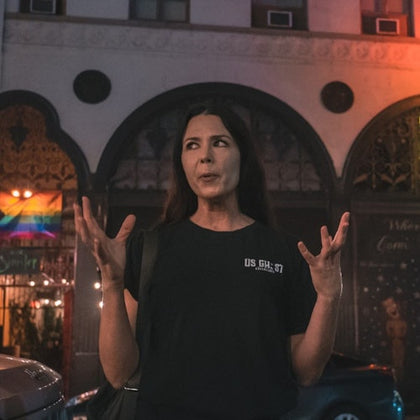 Tour guide expressing with her hands while telling a story to her group