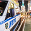 Times Square at night with NYPD police car