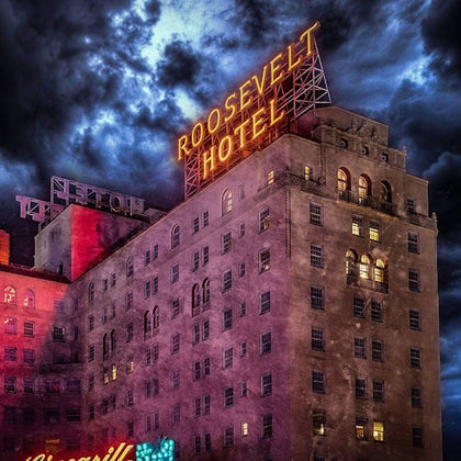 Nighttime photo of the Roosevelt Hotel in Los Angeles, with spooky clouds overhead