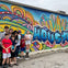 It's time for family photos in Houston's vibrant graffiti district during the Astroville Best of Houston City Tour.