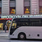 The tour departs in a luxury bus from just off Times Square , outside the Brooklyn Deli
