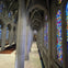 Interior of a gothic-style cathedral with high arches, stained glass windows, and a labyrinth on the floor.