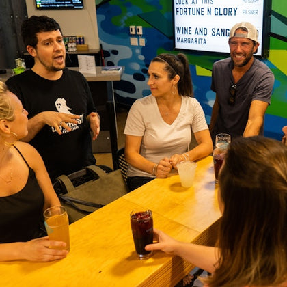 Tour guide talking to guests while having drinks