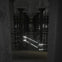 Dimly lit underground space with rows of columns and glowing light streaks across the scene, creating a futuristic ambiance.