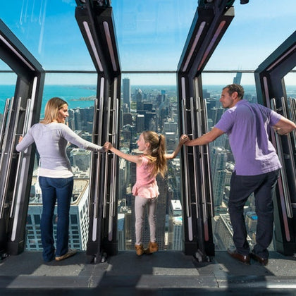 family at the tilt feature on the observation deck 360 Chicago