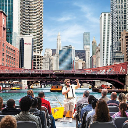 guide and tourists aboard a vessel on an architectural river and lake tour in chicago
