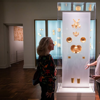 Guests enjoying gold artifacts on display in the Law building