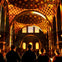 Five people in silhouette facing a brightly lit, ornate cathedral interior with colorful patterns and arched windows.