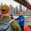 Guide with group outside in Brooklyn, Bronx, Queens Bus Tour