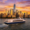 A ferry labeled 'NY Waterway' travels on water with a city skyline and sunset in the background.