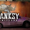 A silver car parked indoors with a painted rhino mural in the background and the text 'BANKSY LIMITLESS' overlaid.
