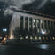 Nighttime photo of the The John A. Wilson Building with spooky clouds overhead