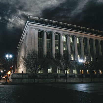 Nighttime photo of the The John A. Wilson Building with spooky clouds overhead