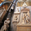 A section of Westminster Abbey featuring memorial statues and plaques, including ones dedicated to literary figures.