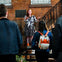 Expressive tour guide telling stories to their group outside of a historic building