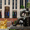 A mermaid statue and a golden Prometheus statue with fountains in a plaza surrounded by flags and a building facade.