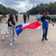 Guests pose with Texas flag at our famous park monument 