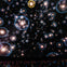 A planetarium show featuring a starry sky with bubble-like visuals projected on the dome above an audience.