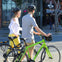 Two riders walk their bikes