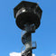 A tall observation tower with a spiral staircase and a hexagonal viewing platform against a clear blue sky.