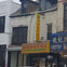 Street view of a building with the storefront sign "Delight Wong Restaurant" in English and Chinese text above it.