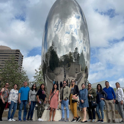 Friends pose alongside a famous art sculpture in Houston during the Astroville Best of Houston City Tour.