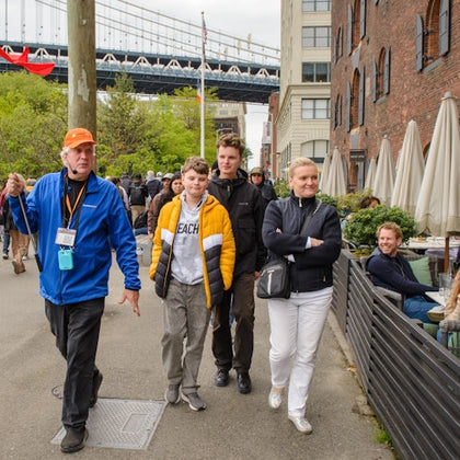 Group shot of guide and guests in Brooklyn, Bronx, Queens Bus Tour