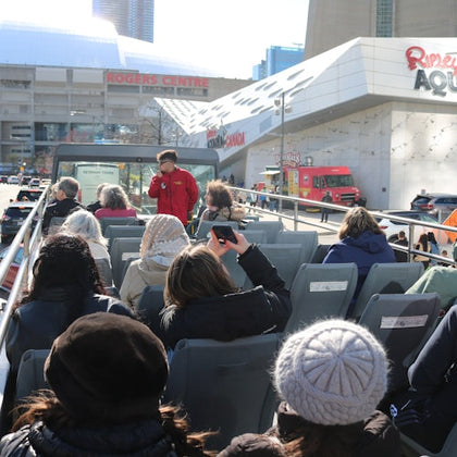 Open top double decker bus, approaching Ripley's Aquarium and Rogers Centre