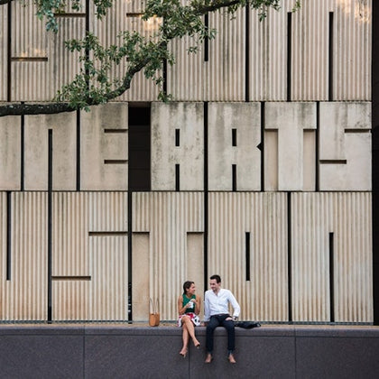 couple taking a break outside the Audrey Jones Beck Building