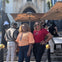 Two ladies pose for a photo in front of the Versace Mansion.