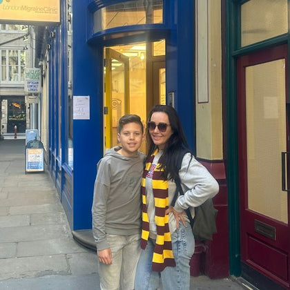 Mother and son standing near building