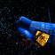A space capsule suspended in a starry background, with its illuminated interior visible.
