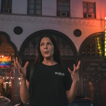 Tour guide expressing her hand while telling a story to her group