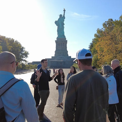 A captivating photo of our tour group at Ellis Island with the majestic Statue of Liberty as the backdrop.
