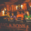 People screaming on a theme park ride with fire, pillars, and a large statue in the background.