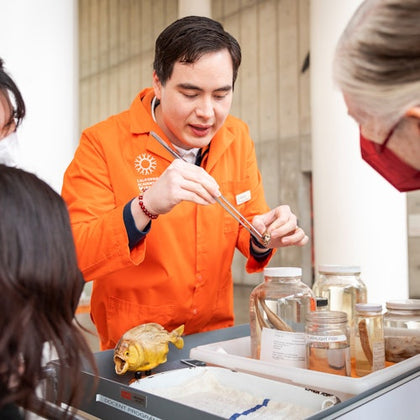 Academy docent showing off specimens on the museum floor