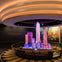 A colorful illuminated scale model of skyscrapers displayed under a circular ceiling at the Top of the Rock Observation Deck.