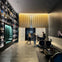 A modern hotel lobby with decorative wall niches, a front desk with staff assisting guests, and sleek furnishings.