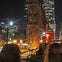 Open top double decker bus tour approaching the Flatiron building in Toronto at night