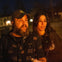 Couple staring into a lantern's glow as they listen to their tour guide