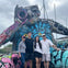 A family on the Miami 3-in-1 City Tours poses in front of a gigantic art installation in Wynwood.
