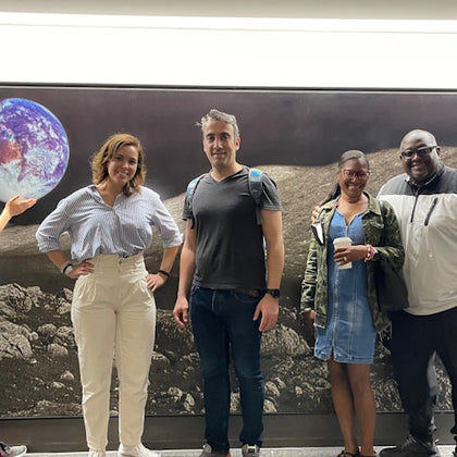 Guests stop for photos in front of the "View from the Moon" during the Astroville Tunnel Tour of Downtown Houston.