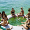 ladies sipping, laughter flowing—a stylish rendezvous of relaxation on the water.