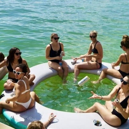 ladies sipping, laughter flowing—a stylish rendezvous of relaxation on the water.