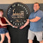 Lovely couple on the Astroville Tunnel Tour pose for picture with our city seal underneath Houston City Hall.