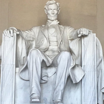The marble statue of Abraham Lincoln seated in the Lincoln Memorial.