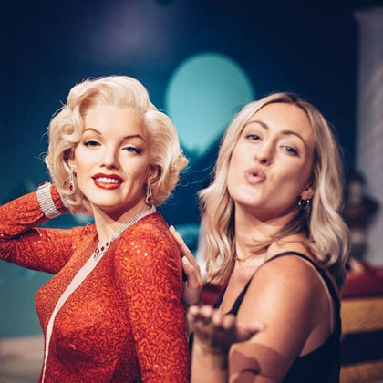 Tourist taking a self with wax figure of Marilyn Monroe at Madame Tussauds Hollywood