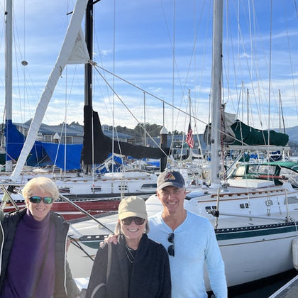 posing for a a photo in front of SV Kindred Spirits after a great day on the water