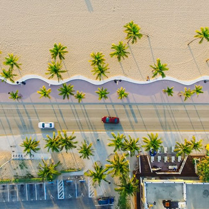 Aerial photo of road next to a beach